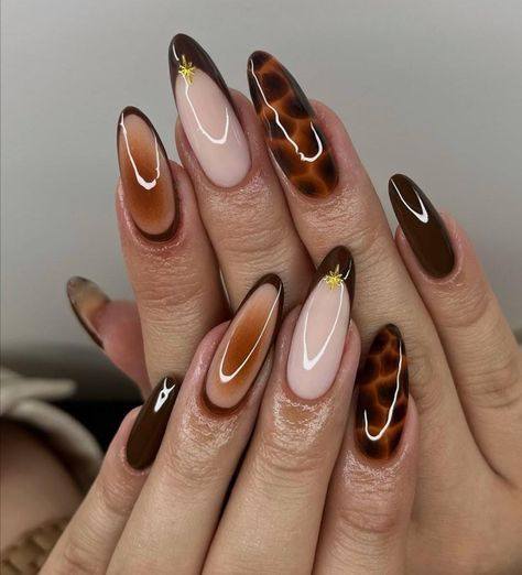 Elegant almond-shaped acrylic nails featuring glossy chocolate brown polish, tortoiseshell nail art, and nude accent nails creating a sophisticated luxury manicure.