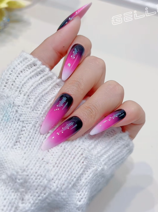 Glossy stiletto nails with a vibrant pink ombré design, black gradient tips, and sleek chrome line accents, creating a bold and trendy modern manicure look.