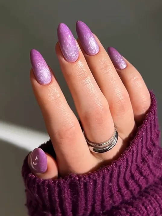 Soft Lavender Velvet Nails Lavender velvet nails with glossy shimmer texture on almond-shaped acrylic nails, featuring soft pastel purple nail art design and elegant trendy manicure inspiration.