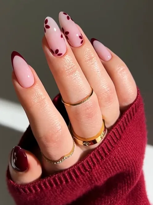 Burgundy French tip nails with glossy pale pink acrylic manicure, featuring elegant dotted nail art accents and classy almond-shaped nail design inspiration.
